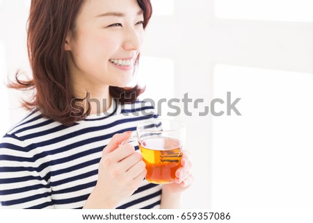 young attractive asian woman who drink tea