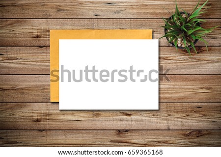 Top view of blank paper page on wood background office desk with different objects. Minimal flat lay style