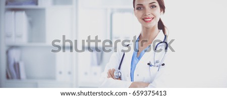 Portrait of young woman doctor with white coat standing in hospital