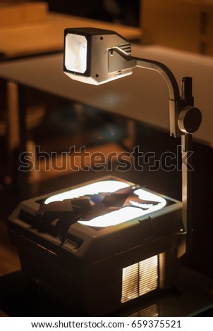 Overhead projector on desk with wolf picture