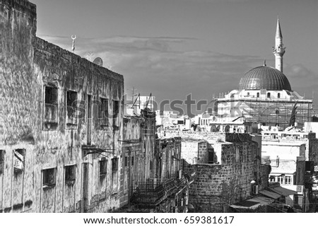 Restoration of Muslim mosque in the old city of Akko. Al-Jazzar mosque as fine example of the Ottoman architecture in old Acre, Israel. Black and white picture