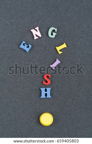 English word on black board background composed from colorful abc alphabet block wooden letters, copy space for ad text. Learning english concept