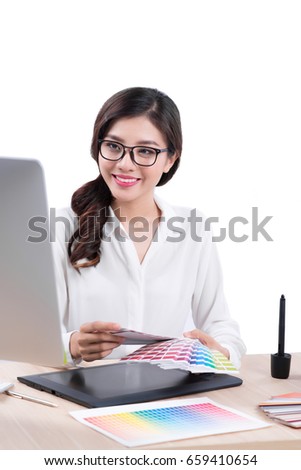 Graphic designer at work. Asian woman sitting on desk.