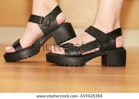 Black female sandals on the leg