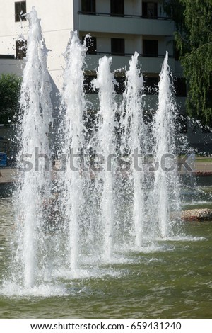 Summer Sultry landscape. Fountain with water in the park