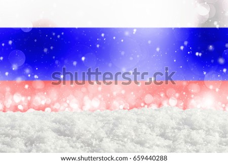 Defocused Russia flag as a winter Christmas background with falling snow, snowdrift and bokeh