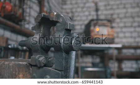 Inside forge workshop - steel vise, close up