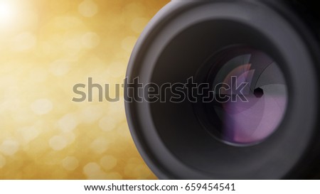 closeup camera lens with blurred bokeh light background.
