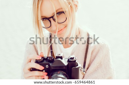 Beauty woman posing in the street with camera