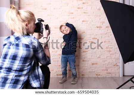 Small boy posing in front of photographer