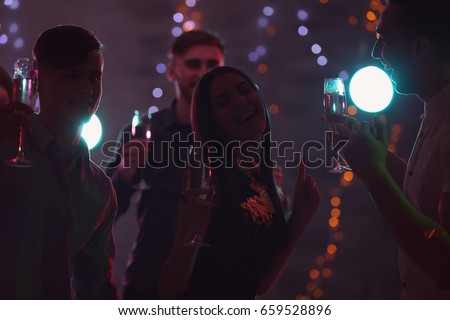 Friends having fun at party in night club