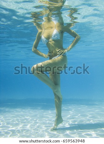 Woman doing exercises in a pool 