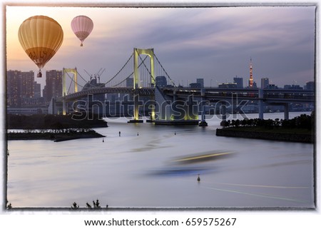 Bird eye view of  Rainbow Bridge from Odaiba . Odaiba  is a popular shopping and entertainment district on a man made island in Tokyo Bay Japan and Colorful hot air balloon on sunset sky.