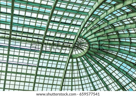 Modern glass roof with metal arches on the ceiling