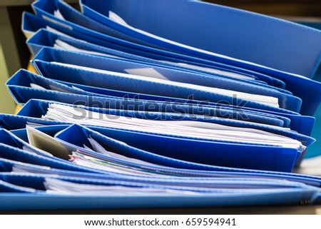 blue file folder documents In a file cabinet . retention of contracts - concept