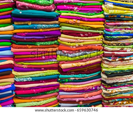 Pile of colorful fabrics and textile in shop