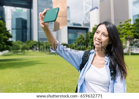 Woman taking selfie in Hong kong city