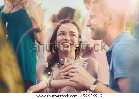 Couple flirting at the party Royalty-Free Stock Photo #659656912