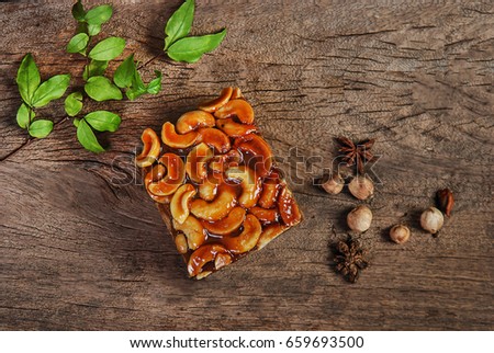 Toffee almond nut cake on wooden background,homemade bakery,flat lay picture