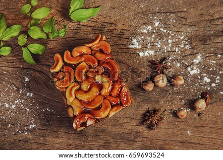 Toffee almond nut cake on wooden background,homemade bakery,flat lay picture