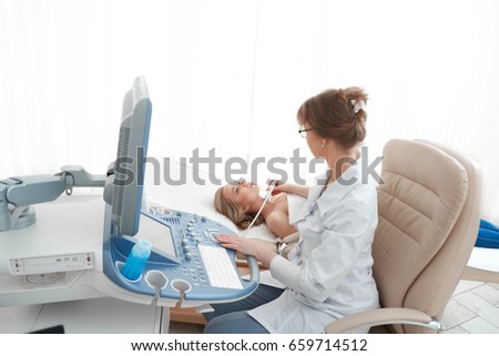 Young woman getting breast ultrasound scanning at the hospital visiting her gynecologist professionalism patient healthcare medicine clinical survey cancer awareness. Royalty-Free Stock Photo #659714512