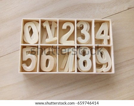 Wooden block numeric set isolated over the wooden background

