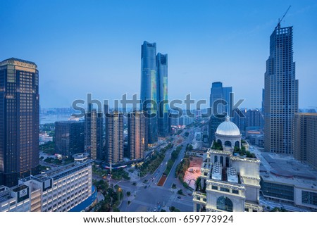 Bird view at Nanchang China. Skyscraper under construction in foreground. Fog, overcast sky and pollution. Bund (Nanchang) area