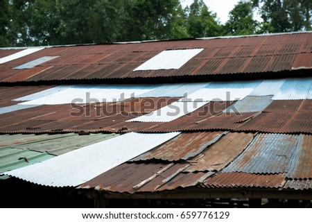 View of old style zinc roof with rust and lichen with 
