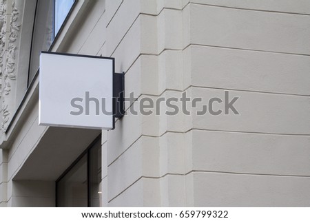 horizontal front view of empty white square signage on a building with classical architecture