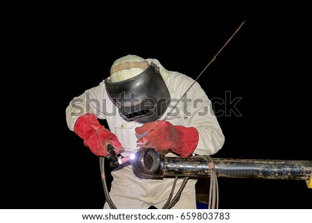 welding man tig steel pipe welding, Industrial automotive part in factory on black background