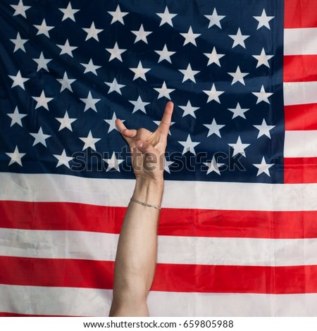 rock n roll on background of American flag, gesture with your hands