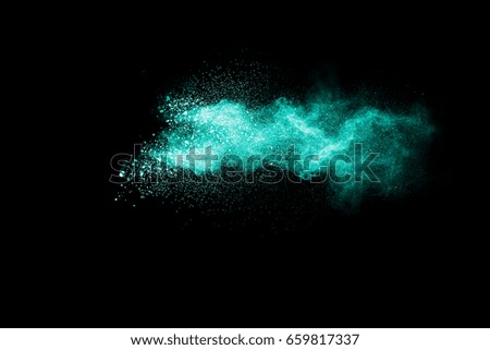 Green powder explosion isolated on black background.