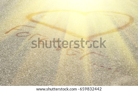 Heart drawn with chalk in the sun