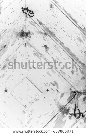 Diamond Shaped Pattern on Old Rustic White Door With Rusted Handle Vertical