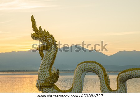 Naga statue at Kwan Phayao: Kwan Phayao is a popular attraction of the Phayao area. Not just in Phayao, the freshwater lake is among the largest semi natural wetlands in the entire northern Thailand.