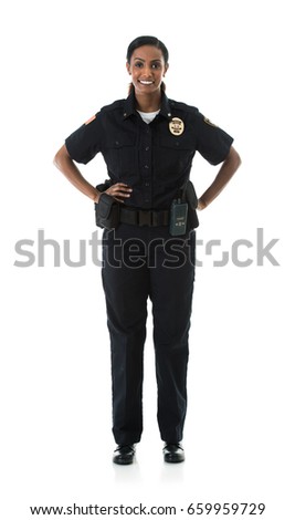 Police: Friendly Female Officer Looking At Camera Royalty-Free Stock Photo #659959729