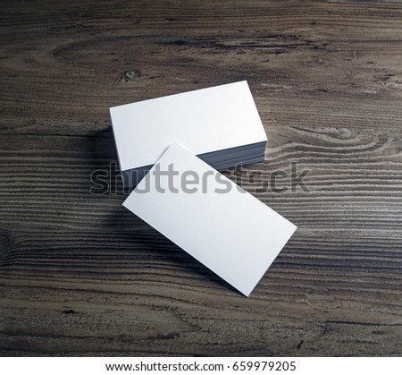 Photo of blank business cards on wooden table background. Presentation template for designers.