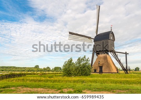 The Noordeveldse molen near the Dutch village of Dussen in North Brabant is a thatched stone hollow post mill with wooden upper house originally built in 1795. The photo was taken in springtime.