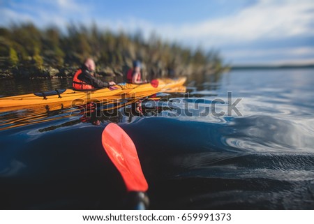 A process of kayaking in the lake skerries, with colorful canoe kayak boat paddling, process of canoeing, vibrant summer picture