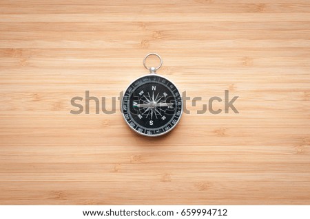 Compass on wooden table.