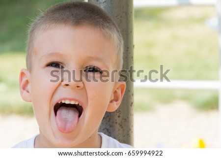 Little boy smiling outdoors