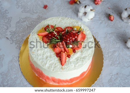 Luxury white cake with heart decoration over white background