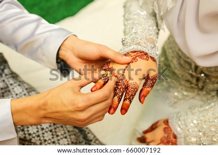 male and female hand, image of mehendi henna pattern.Beautiful composition, fabric background banner. Round mandala abstract flowers, flowers lilac. Close up professional art photo