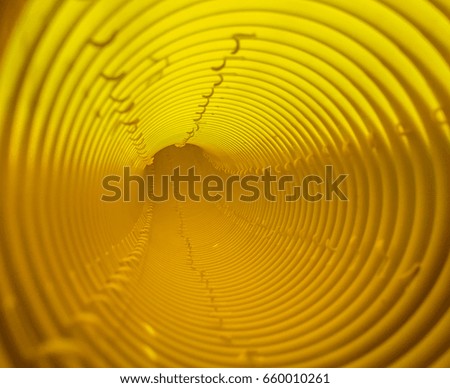 Inside the striped orange tunnel pipe, abstract background. 