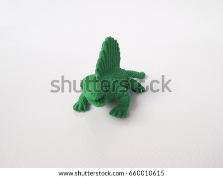 Spinosaurus dinosaur model made from green rubber isolated on white background.  