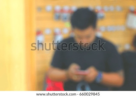 Blurry focus on a man on smart-phone