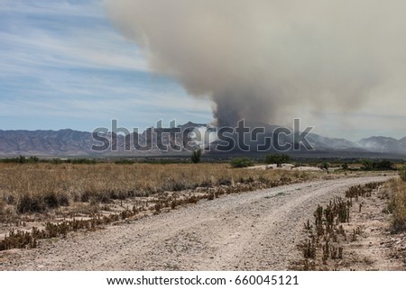 Known as the Lizard Fire on June 10, 2017 at the Dragoon Mountains in southeast Arizona USA, wildfire pollution in billowing black and brown smoke in outdoor nature landscape 