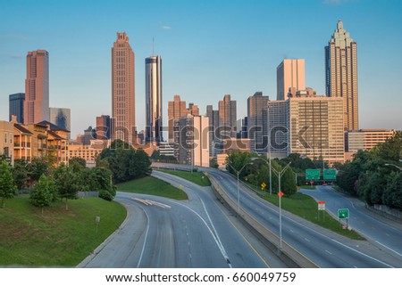 Horizontal photo of the Atlanta skyline as seen in the early morning from the Jackson Street Bridge (all business names on buildings have been edited out of the photo)