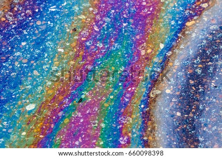 Gasoline that had leaked onto a wet parking lot creates a rainbow oil slick
