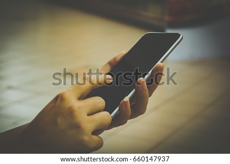 Man use smartphone at restaurants. Hand touching screen.